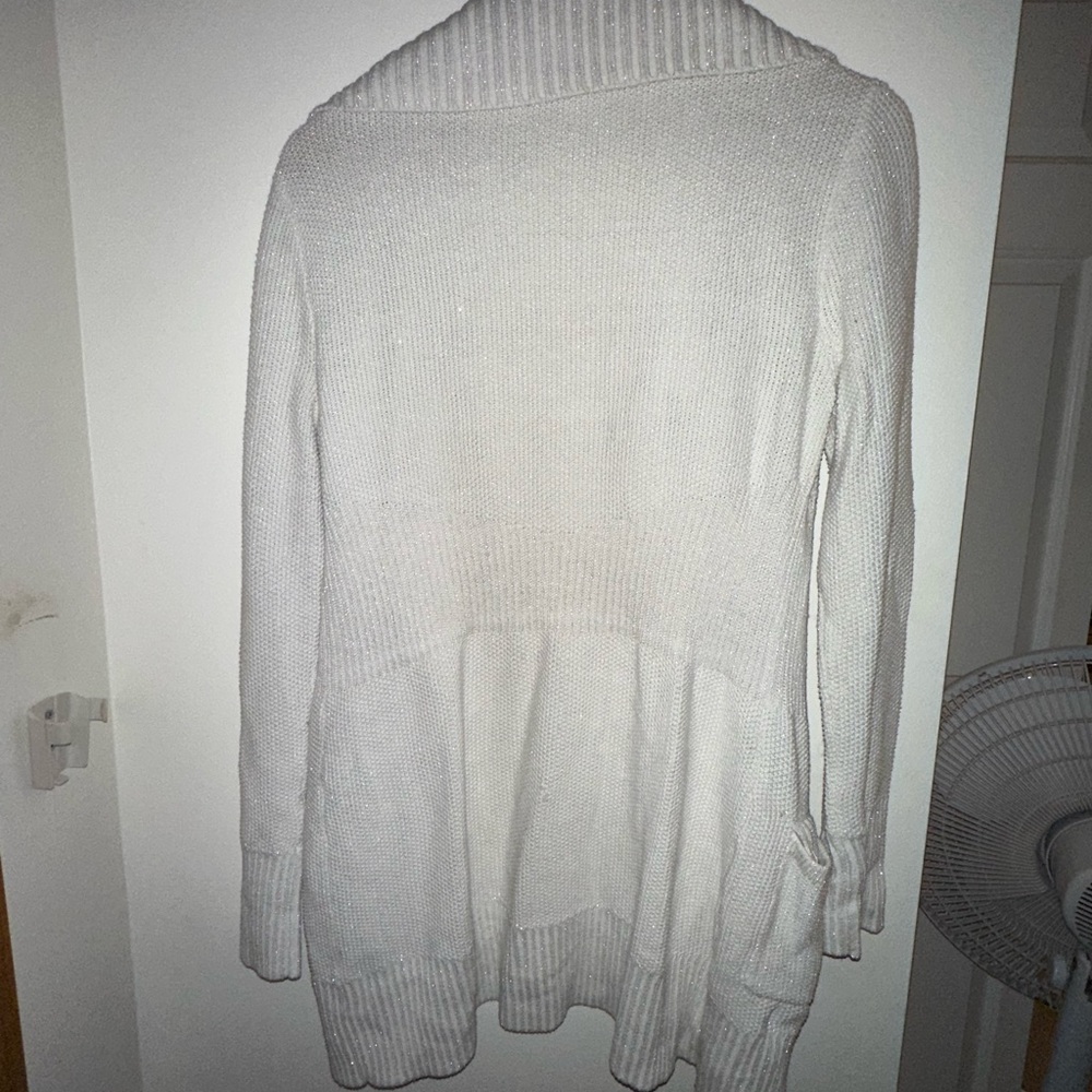 White Cardigan, with subtle silver shine beneath.